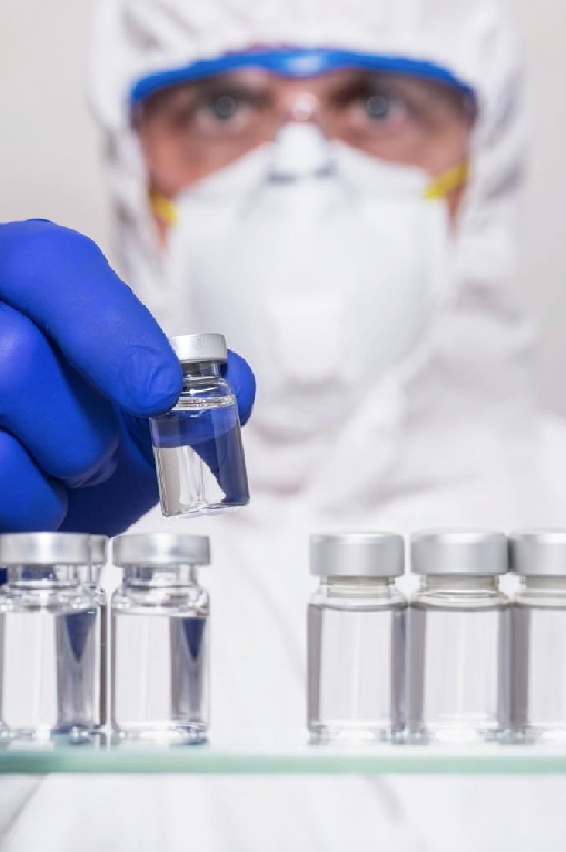 Scientist carefully posing a vial